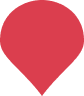 A solid red map pin marker with a rounded top and pointed bottom on a light grey background.